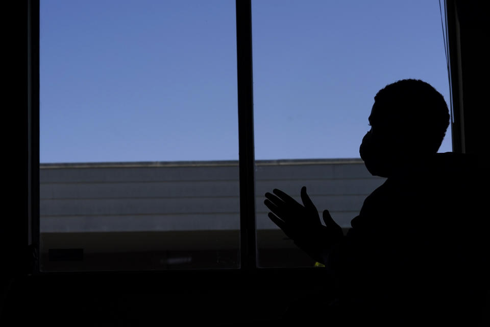 "D.Y.," a teenager who is currently living in a foster-care group home, takes part in an AP interview, Friday, May 21, 2021, in the facility's administrative office in University Place, Wash. D.Y., who is not being named by the Associated Press to protect his identity, is currently suing the Washington state Department of Children, Youth and Families, alleging that the state has provided inadequate care after bouncing him through more than 50 placements before the COVID-19 pandemic. An Associated Press analysis of state data reveals that the coronavirus pandemic has destabilized the foster care system, leaving children with no parental visits, unprecedented delays in family court cases and limited access to services demanded for reunification. (AP Photo/Ted S. Warren)