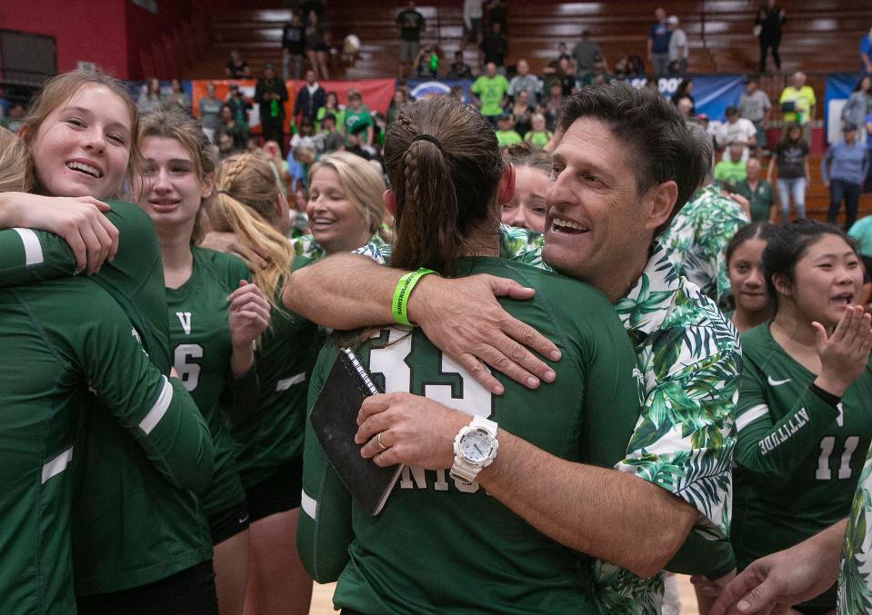 Venice High School Head Coach Brian Wheatley hugs senior Ashley Reynolds (33) as they celebrate after their victory over Hagerty High School during their FHSAA Class 7A State Championship volleyball match at Polk State College in Winter Haven Saturday night. November 12, 2022