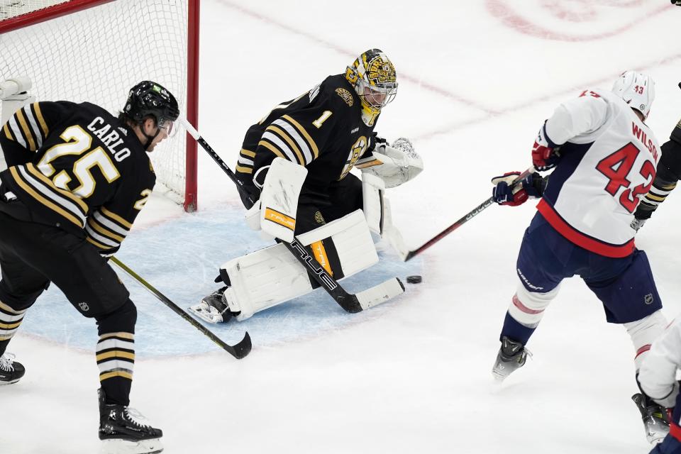 Boston Bruins' Jeremy Swayman (1) blocks a shot by Washington Capitals' Tom Wilson (43) during the first period of an NHL hockey game, Saturday, Feb. 10, 2024, in Boston. (AP Photo/Michael Dwyer)