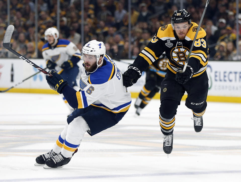 St. Louis Blues' Joel Edmundson (6) sends Boston Bruins' Karson Kuhlman (83) airborne during the second period in Game 7 of the NHL hockey Stanley Cup Final, Wednesday, June 12, 2019, in Boston. (AP Photo/Michael Dwyer)