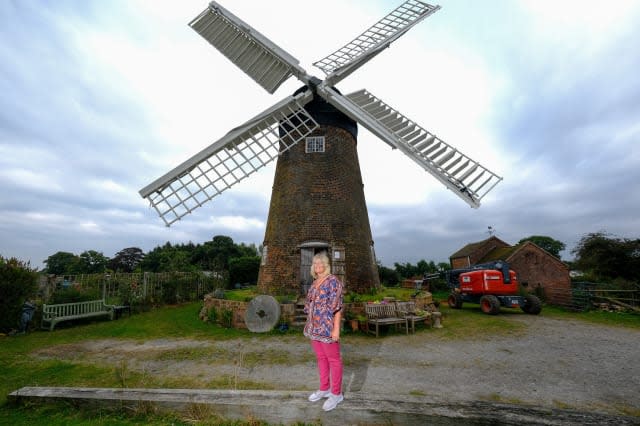 Woman completes ultimate DIY renovation project of one of Britain's last fully working windmills after using cherry picker to paint the sails by hand