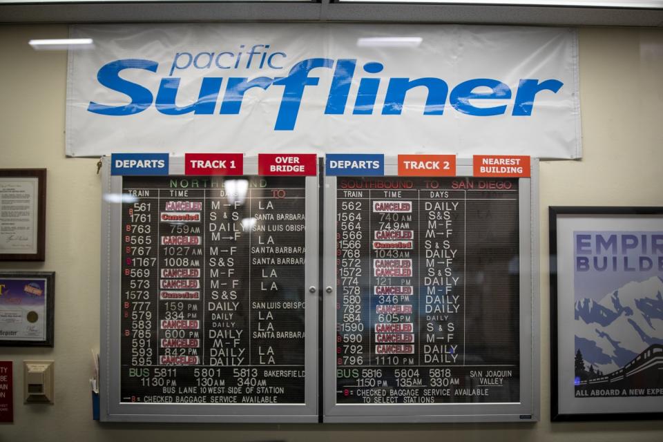 The Pacific Surfliner train schedule shows numerous cancelled train routes at the nearly-empty Santa Ana Regional Transportation Center amid coronavirus (COVID-19) physical distancing restrictions in Santa Ana, CA, on April 9, 2020.
