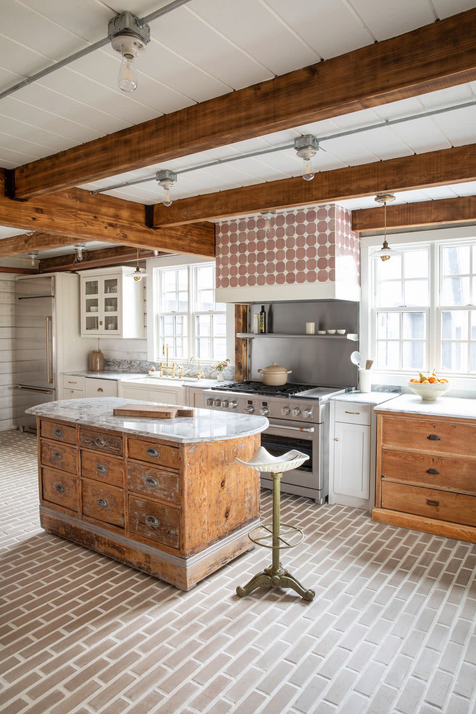 a kitchen that has an old wooden island and a marble top