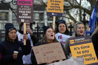 Nurses of the nearby St. Thomas' Hospital protest, in London, Monday, Feb. 6, 2023. Tens of thousands of nurses and ambulance staff walked off the job in the U.K. Monday in what unions called the biggest strike in the history of Britain’s public health system. (AP Photo/Frank Augstein)