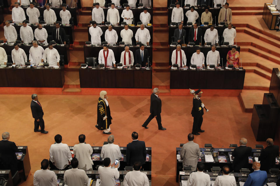 Sri Lankan President Gotabaya Rajapaksa, center right, with speaker Karu Jayasuriya, center left, walk in the well of the house as he arrives to address the ceremonial inauguration of the session in Colombo, Sri Lanka, Friday, Jan. 3, 2020. (AP Photo/Eranga Jayawardena)