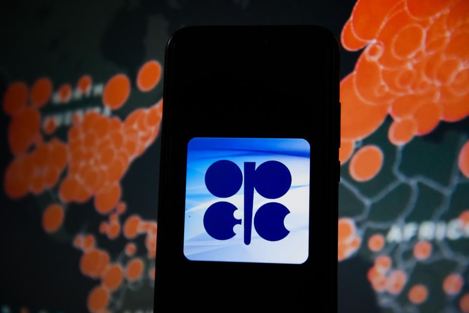 POLAND - 2020/03/19: In this photo illustration an OPEC logo seen displayed on a smartphone with a World map of COVID 19 epidemic on the background. (Photo Illustration by Omar Marques/SOPA Images/LightRocket via Getty Images)