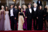 Vicki Berlin, from left, Charlbi Dean, Ruben Östlund, Jean-Christophe Folly, Arvin Kananian, Woody Harrelson, Dolly De Leon, Sunnyi Melles, Ralph Schicha, Zlatko Buric, Iris Berben, and Carolina Gynning pose for photographers upon arrival at the premiere of the film 'Triangle of Sadness' at the 75th international film festival, Cannes, southern France, Saturday, May 21, 2022. (AP Photo/Daniel Cole)