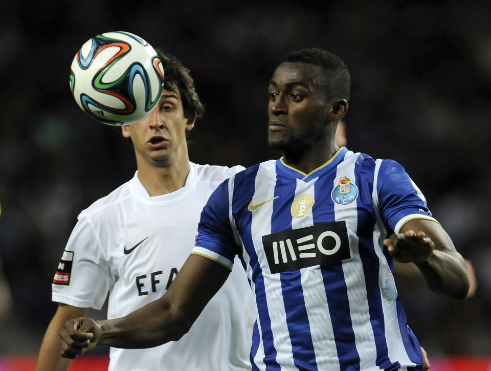 FC Porto's Jackson Martinez, from Colombia, eyes the ball past Academica's Paulo Grilo, left, in a Portuguese League soccer match at the Dragao stadium in Porto, Portugal, Sunday, April 6, 2014. Porto will play Sevilla in a Europa League Quarter-final, second leg soccer match on Tuesday, April 10. (AP Photo/Paulo Duarte)