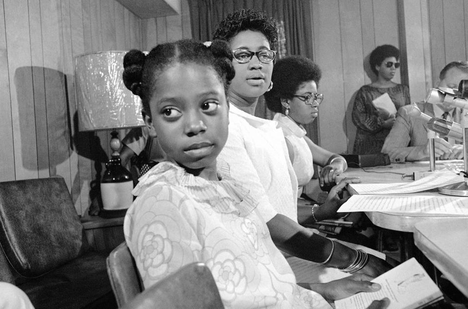 Mrs. Abernathy, wife of Rev. Ralph David Abernathy, speaks at a news conference in Charleston, South Carolina, June 23, 1969 where she told of a hunger strike by her jailed husband. With her are two of their children Donzaleigh, left, and Juandalynn, right. 