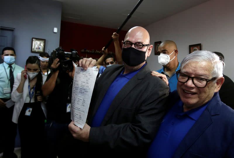 Rodrigo Campos shows the marriage certificate next to his partner Marcos Castillo during their marriage ceremony, after Costa Rica legalised same-sex marriage, in San Jose