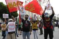 Supporters hold caricatures of congressmen as they call for the franchise renewal of ABS-CBN outside the ABS-CBN headquarters in Quezon City, Philippines, Friday, July 10, 2020. Philippine lawmakers voted Friday to reject the license renewal of the country's largest TV network, shutting down a major news provider that had been repeatedly threatened by the president over its critical coverage. (AP Photo/Aaron Favila)