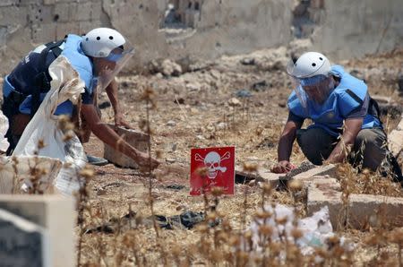 Civil defense members prepare to safely detonate cluster bombs in the rebel-held area in Deraa, Syria July 26, 2017. REUTERS/Alaa al-Faqir