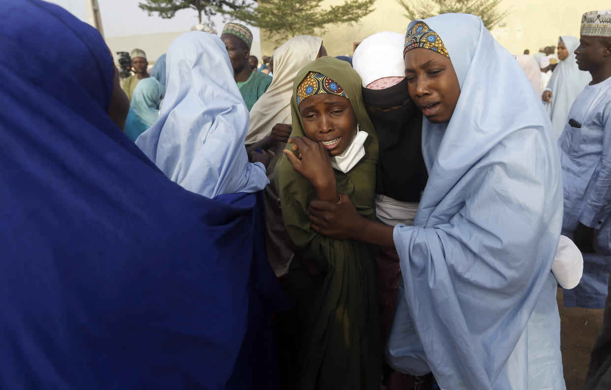 Parents are reunited with their daughters in Jangabe, Nigeria, Wednesday, March 3, 2021. More than 300 schoolgirls kidnapped last week in an attack on their school in northwest Nigeria have arrived in Jangabe after been freed on Tuesday. The Girls were abducted few days ago from Government Girls Secondary School in Jangabe in Zamfara state (AP Photo/Sunday Alamba)