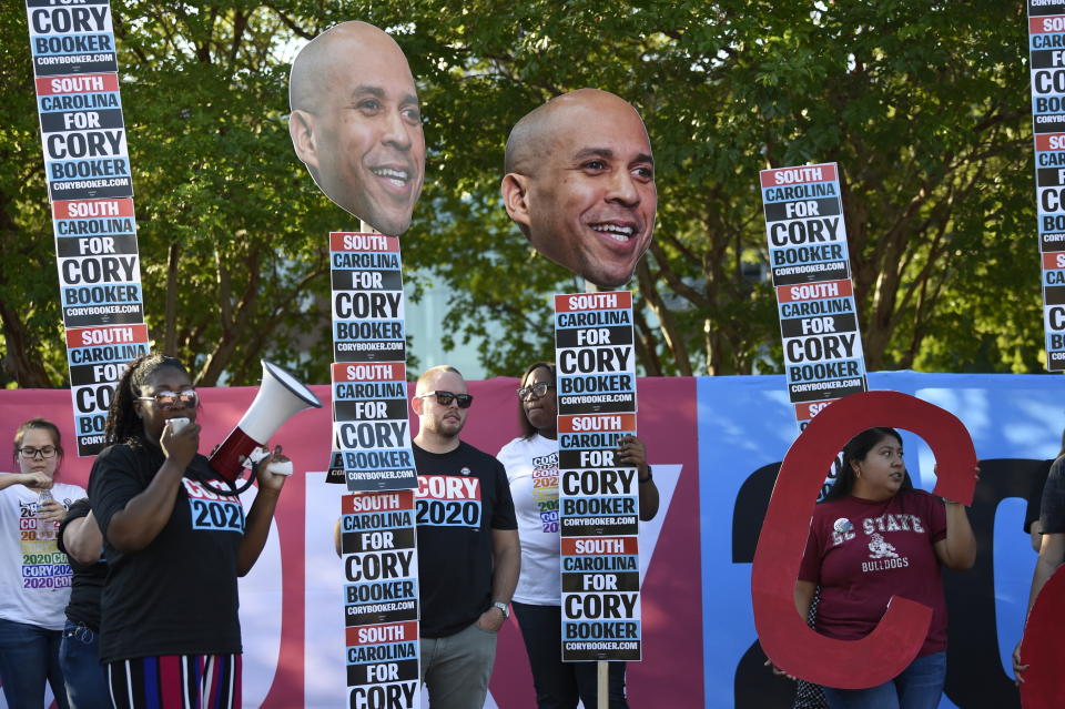 Supporters of New Jersey Sen. Cory Booker rally for the Democratic presidential hopeful ahead of Majority Whip Jim Clyburn's "World Famous Fish Fry" on Friday, June 21, 2019, in Columbia, S.C. (AP Photo/Meg Kinnard)