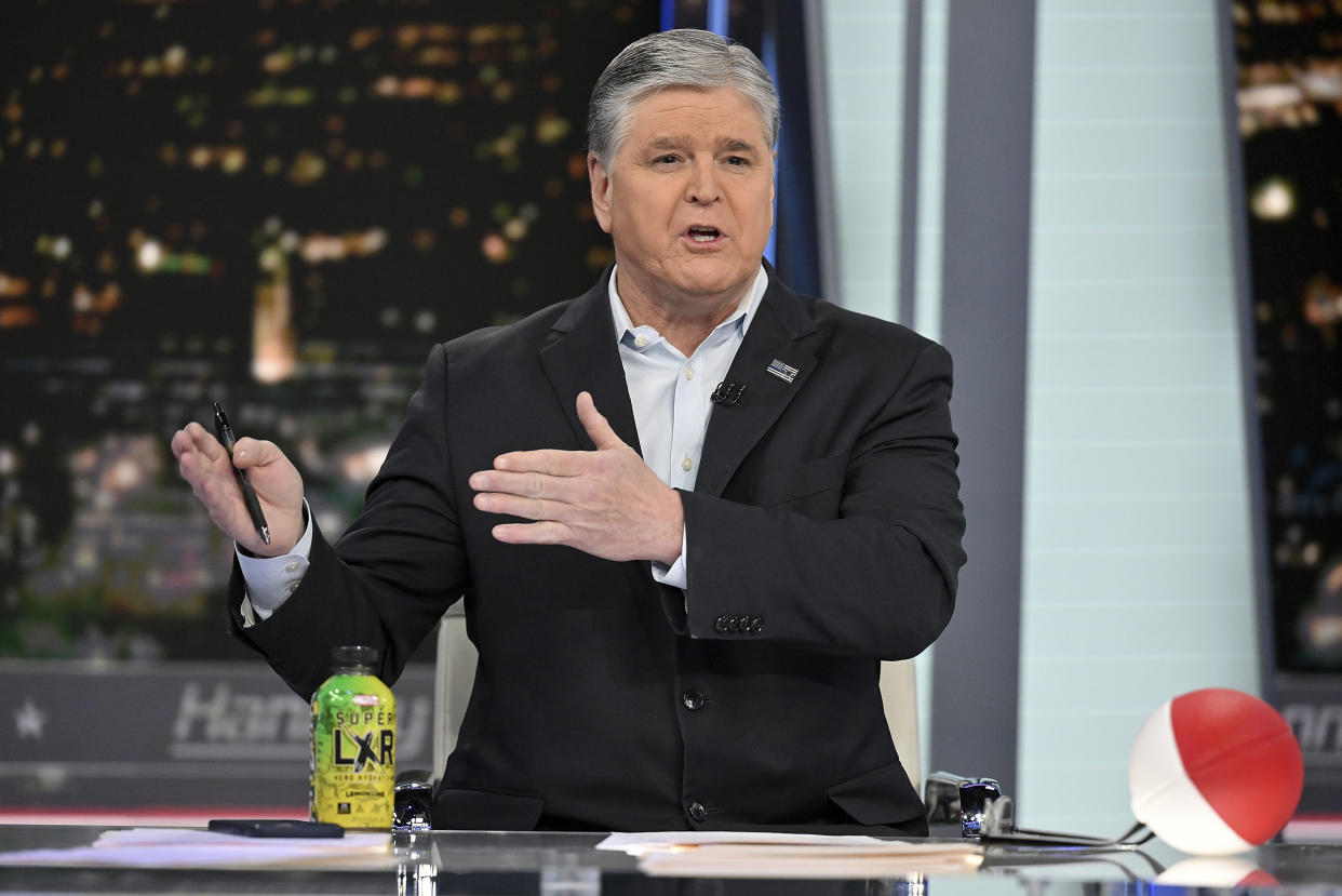 FILE- Fox News commentator Sean Hannity speaks during an interview at Fox News Studios, March 16, 2023, in New York. Dominion Voting Systems' defamation lawsuit against Fox News for airing bogus allegations of fraud in the 2020 election is set to begin trial on Monday, April 17, 2023, in Delaware. Fox News stars Tucker Carlson and Sean Hannity and founder Rupert Murdoch are among the people expected to testify over the next few weeks. (Photo by Evan Agostini/Invision/AP, File)