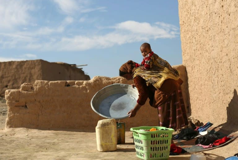 Syrian woman Najwa Abdullah, 27, washes clothes at her home in the Al-Shallal suburb of Al-Hol in Syria's Hasakeh province after Syrian Democratic Forces re-took control of the area from the Islamic State group