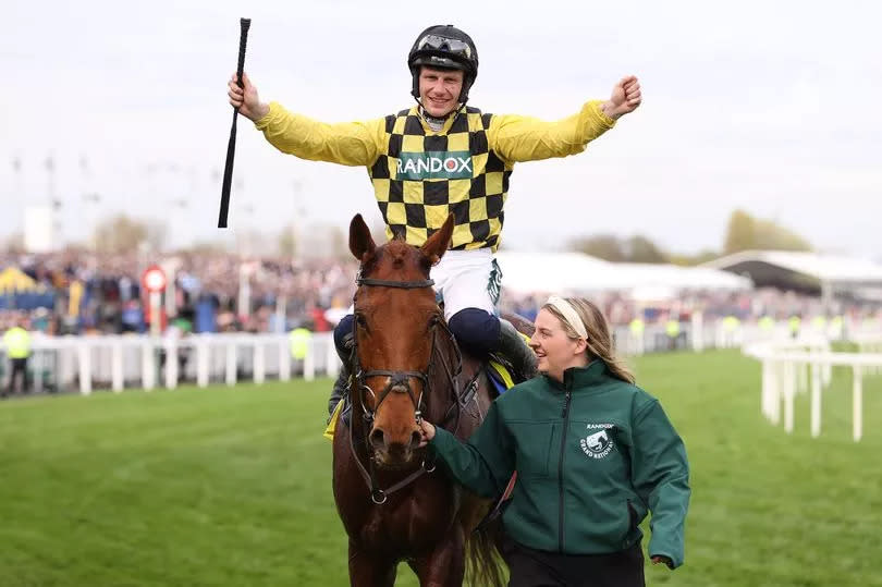 Paul Townend celebrates after riding Dancing City to victory in the Cavani Sartorial Menswear Sefton Novices' Hurdle Race on Ladies Day at the 2024 Randox Grand National Festival at Aintree Racecourse on Friday, April 12 2024