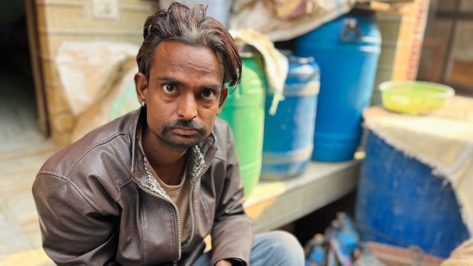 Ramesh sits outside his flat in Delhi. - Aishwarya Iyer/CNN
