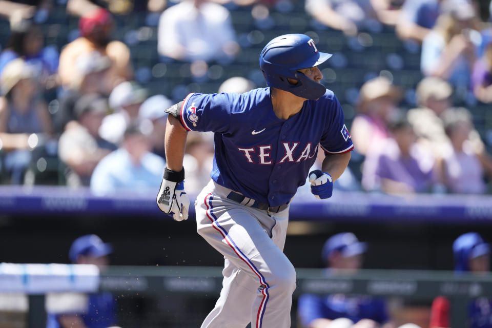 Texas Rangers' Corey Seager heads up the first-base line after connecting for a double to drive in two runs off Colorado Rockies starting pitcher Jose Urena in the second inning of a baseball game Wednesday, Aug. 24, 2022, in Denver. (AP Photo/David Zalubowski)