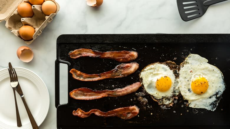 Griddle with bacon and eggs