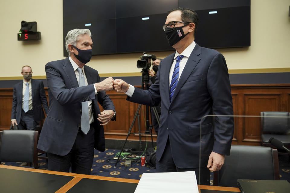 Federal Reserve Chairman Jerome Powell fist bumps Treasury Secretary Steven Mnuchin after a House Financial Services Committee hearing on Capitol Hill in Washington, Wednesday, Dec. 2, 2020. (Greg Nash/Pool via AP)