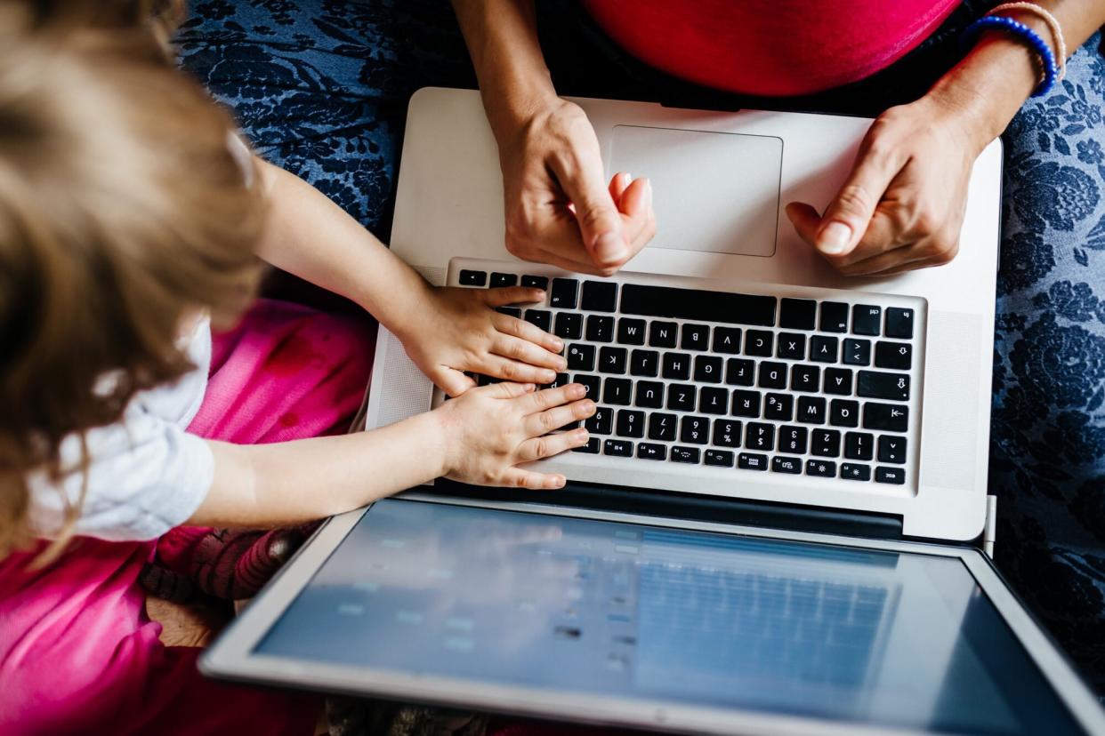 An image of a mom and her toddler at a computer.