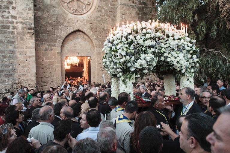 Greek Cypriots attend a Good Friday mass in the St George Exorinos church in Famagusta on April 18, 2014