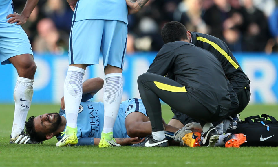 Manchester City's Sergio Aguero receives treatment to an injury