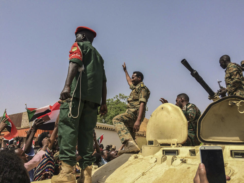 Sudanese forces celebrate after officials said the military had forced longtime autocratic President Omar al-Bashir to step down after 30 years in power in Khartoum, Sudan, Thursday, April 11, 2019. (AP Photo)