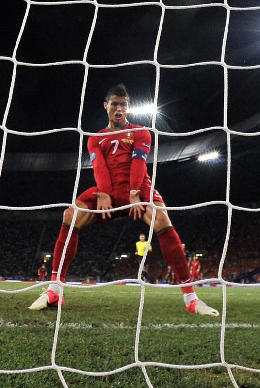 TOPSHOTS Portuguese forward Cristiano Ronaldo celebrates after scoring during the Euro 2012 football championships match Portugal vs. Netherlands on June 17, 2012 at the Metalist stadium in Kharkiv. AFP PHOTO / FILIPPO MONTEFORTEFILIPPO MONTEFORTE/AFP/GettyImages