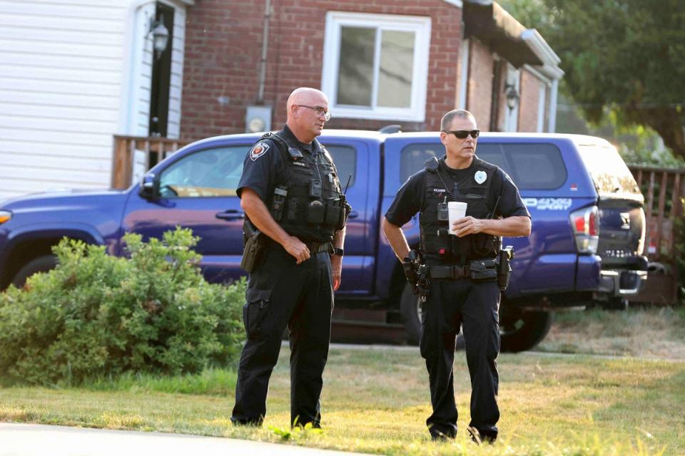 Police officers talk near the home of Trump shooting suspect Thomas Crooks (REUTERS)