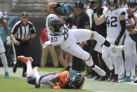 Jacksonville Jaguars tight end James O'Shaughnessy (80) is knocked out of bounds by Denver Broncos safety Kareem Jackson (22) during the first half of an NFL football game, Sunday, Sept. 19, 2021, in Jacksonville, Fla. (AP Photo/Phelan M. Ebenhack)