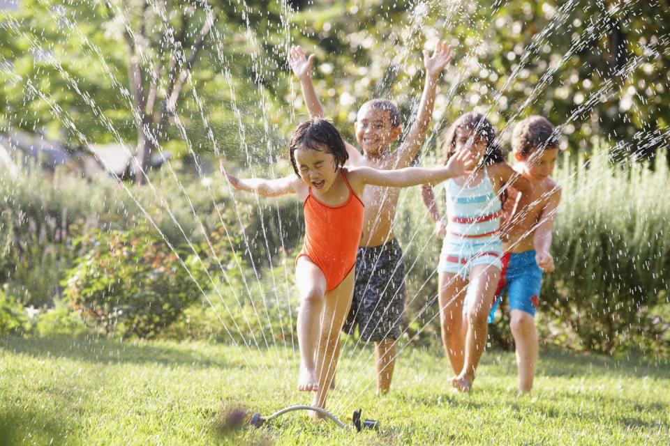 summer activities run in the sprinklers