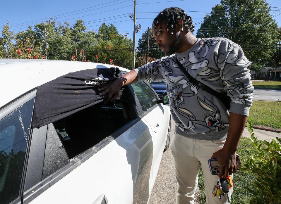 Yancy Davis had his 2020 Kia Forte stolen late September in Louisville. It was later recovered by police about a week later with damage to the interior where the thieves were able to start it without a key. Davis shows the back window of the car where the window was smashed with a hammer that is still in the back seat. October 10, 2023