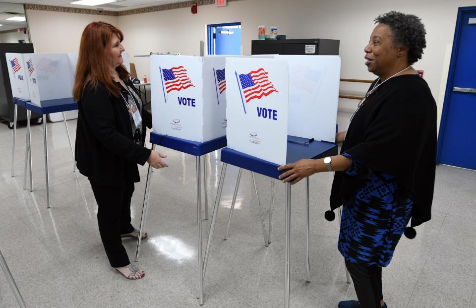 Linda Moreno (left) and Leisha Bean Clark set up voting booths at the Ezell Hester Community Center in Boynton Beach so that early voting can take place in the 2020 Presidential Preference Primary. Saturday, March 7, 2020.