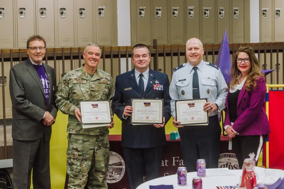 GFPS Supt. Tom Moore (far left) and Montana OPI Supt. Elsie Arntzen (far right) pose with Purple Star Champion Award winners Col. Christopher Karns of Malmstrom Air Force Base, retired Master Sgt. Michael Wonch and retired Lt. Col. Brian Holbein of the JROTC program at the Purple Up Recognition Lunch Thursday.