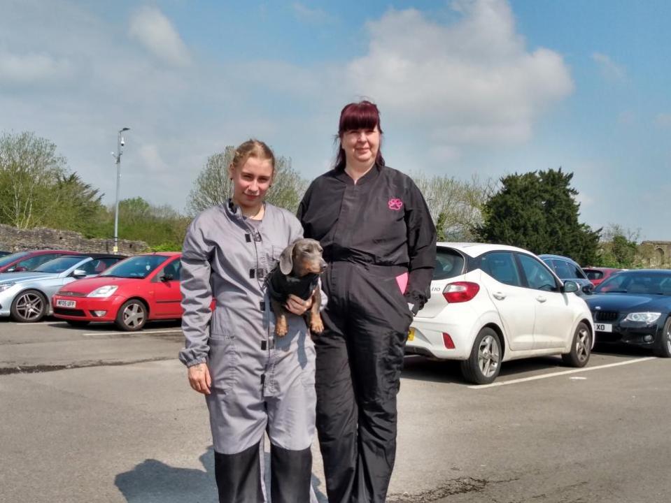 South Wales Argus: Julie White, right, and staff member Tia Ashton, holding miniature dachshund Scooter, pictured at the Dell car park. 