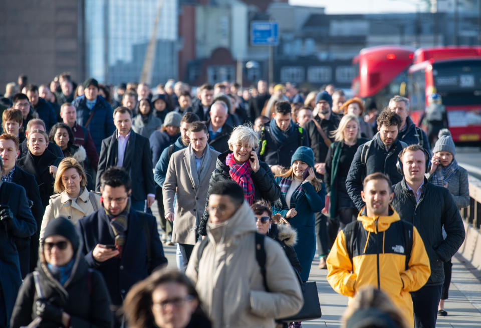 General view of commuters crossing London Bridge, in central London, during the morning rush hour, as the Government's top scientist warned that up to 10,000 people in the UK are already infected with Covid-19.