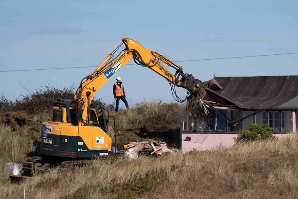 The house of local resident being demolished as it is close to the cliff edge at Hemsby (PA)