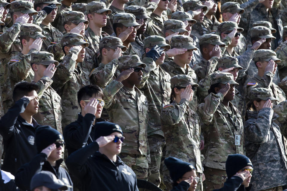 Cadets salute during the National Anthem prior to the NCAA college football game between the Army Black Knights and Massachusetts at Michie Stadium, Saturday, Nov. 20, 2021, in West Point, N.Y. The U.S. military academies provide a key pipeline into the leadership of the armed services and have welcomed more racially diverse students each year for the better part of the last decade. (AP Photo/Eduardo Munoz Alvarez)