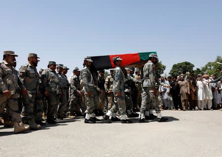 Afghan security forces carry the coffin of an Afghan soldier, who was killed last night during gun fighting between Afghan border forces and Pakistani forces in Torkham, during his funeral in Nangarhar province, Afghanistan province June 14, 2016. REUTERS/Parwiz