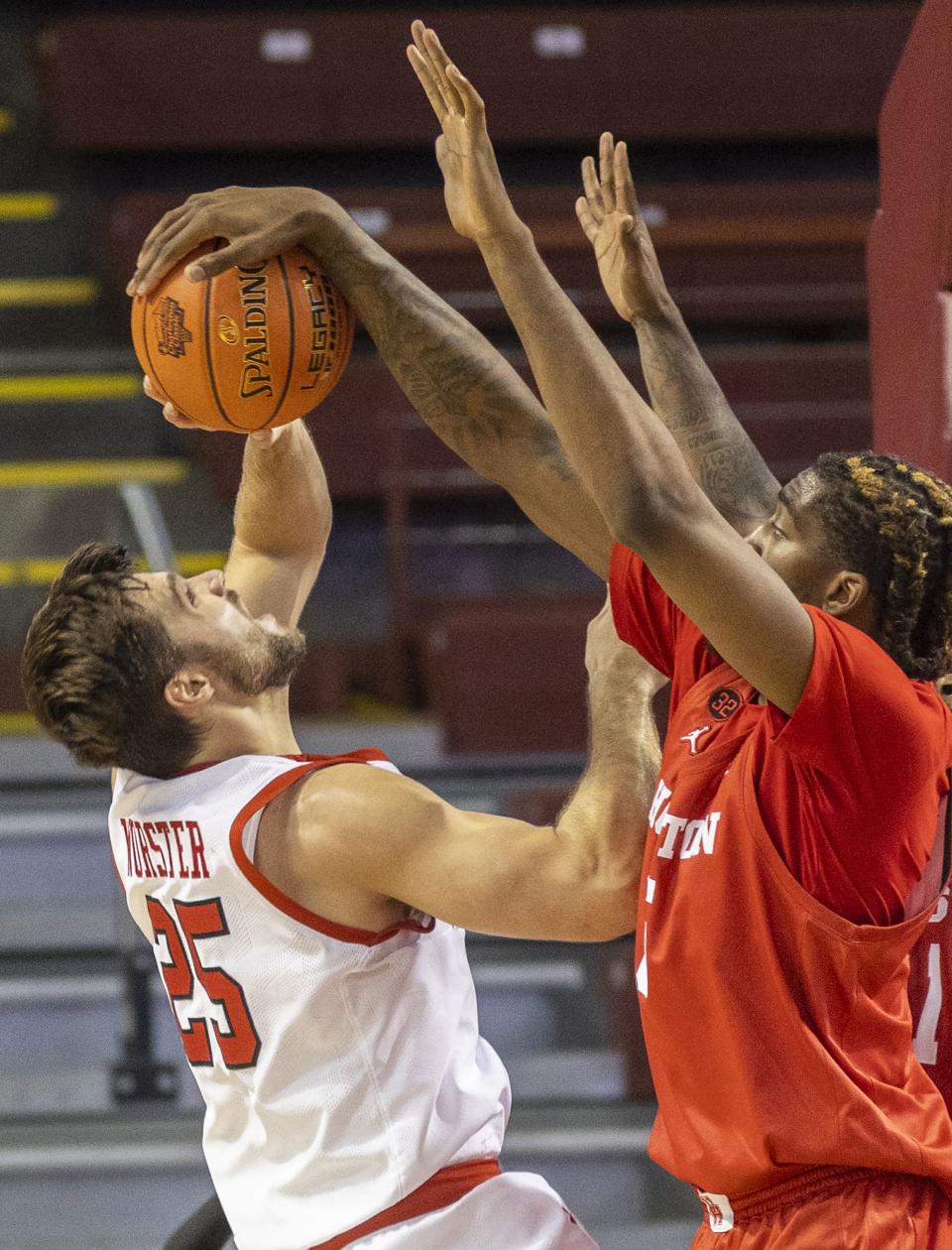 Houston’s Ja’Vier Francis, right, blocks a shot by Utah’s Rollie Worster (25) in the first half of an NCAA college basketball game during the Charleston Classic in Charleston, S.C., Friday, Nov. 17, 2023. | Mic Smith, Associated Press
