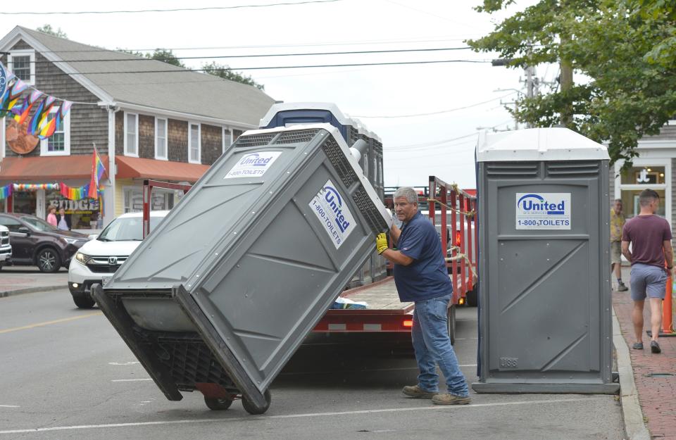 United Site Services supervisor Ron Jennings unloads one of 18 portable toilets that were brought in Thursday and placed near Provincetown Town Hall. The town of Provincetown has declared a sewer emergency for properties on the vacuum sewer system.