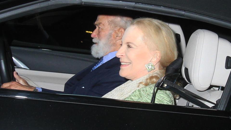 Princess Michael smiles in passenger seat as Prince Michael drives