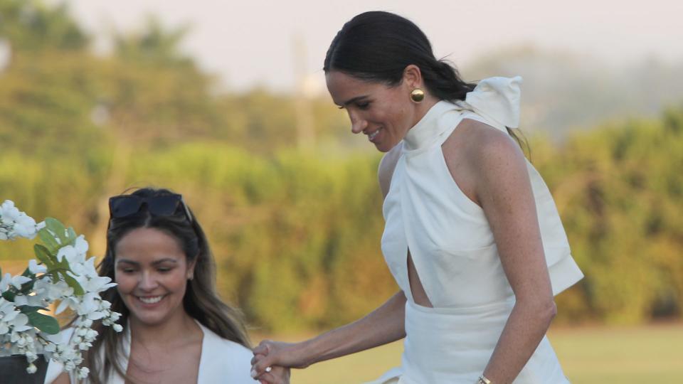 Meghan Markle at the Royal Salute Polo Challenge wearing a white backless number, complete with bow