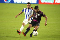 Mexico midfielder Jonathan Dos Santos (6) shields the ball from Honduras defenseman Diego Rodriguez during the second half of a CONCACAF Gold Cup soccer match Saturday, July 24, 2021, in Glendale, Ariz. (AP Photo/Rick Scuteri)