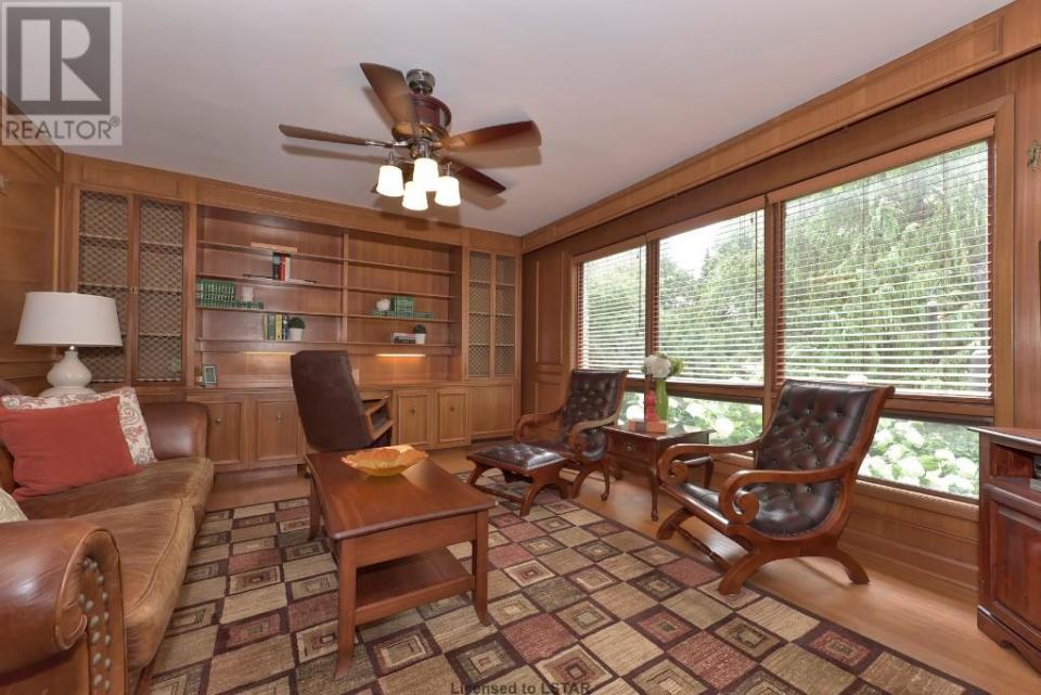 <p><span>1058 Fraser Ave., London, Ont.</span><br> The classically-designed home sits on a quiet tree-lined street, and brings some of that wooded feel inside with this paneled office.<br> (Photo: Zoocasa) </p>