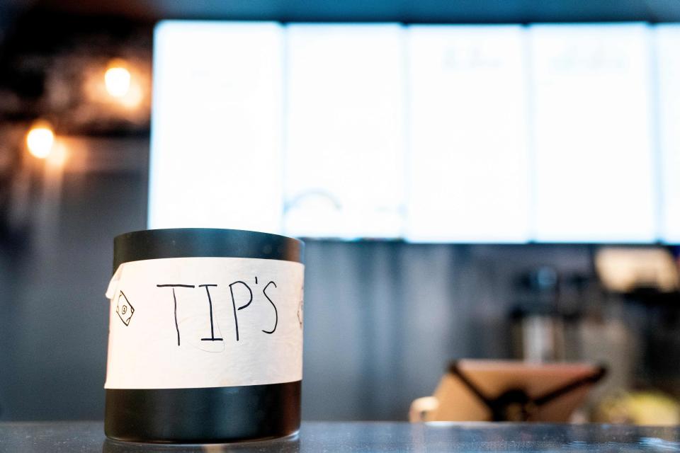 A tip jar sits on a countertop at a store in Washington, DC, on March 17, 2023. - To tip, or not to tip? That is the question many Americans are grappling with in a country where the tip is king -- but even at a grocery store? Or for a bunch of flowers? (Photo by Stefani Reynolds / AFP) (Photo by STEFANI REYNOLDS/AFP via Getty Images)