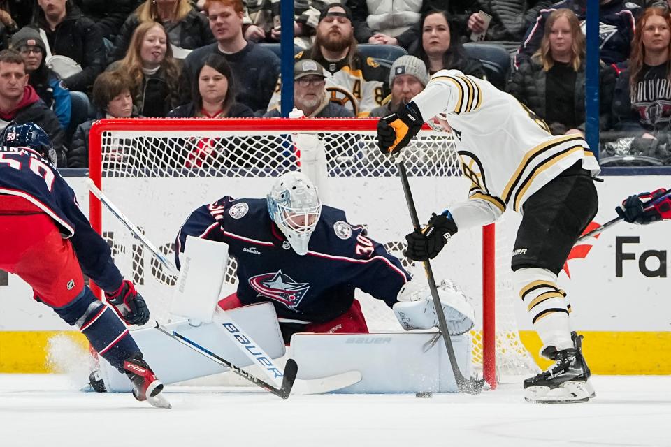 Jan 2, 2024; Columbus, Ohio, USA; Columbus Blue Jackets goaltender Spencer Martin (30) saves a shot from Boston Bruins right wing David Pastrnak (88) during the first period of the NHL hockey game at Nationwide Arena.
