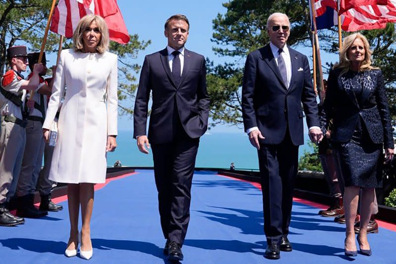 U.S. President Joe Biden and first lady Jill Biden walk with French President Emmanuel Macron and his wife Brigitte Macron while arriving at a ceremony marking the 80th anniversary of D-Day at the Normandy American Cemetery, in Colleville-sur-Mer, France. on Thursday. Photo by Ambassade US France/UPI